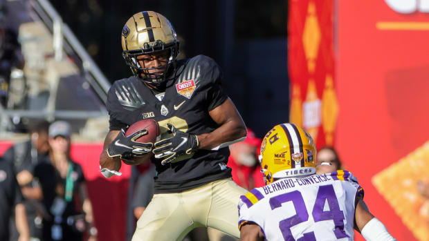 Purdue Boilermakers wide receiver TJ Sheffield (8) catches a pass in front of LSU Tigers cornerback Jarrick Bernard-Converse (24) during the second half at Camping World Stadium.